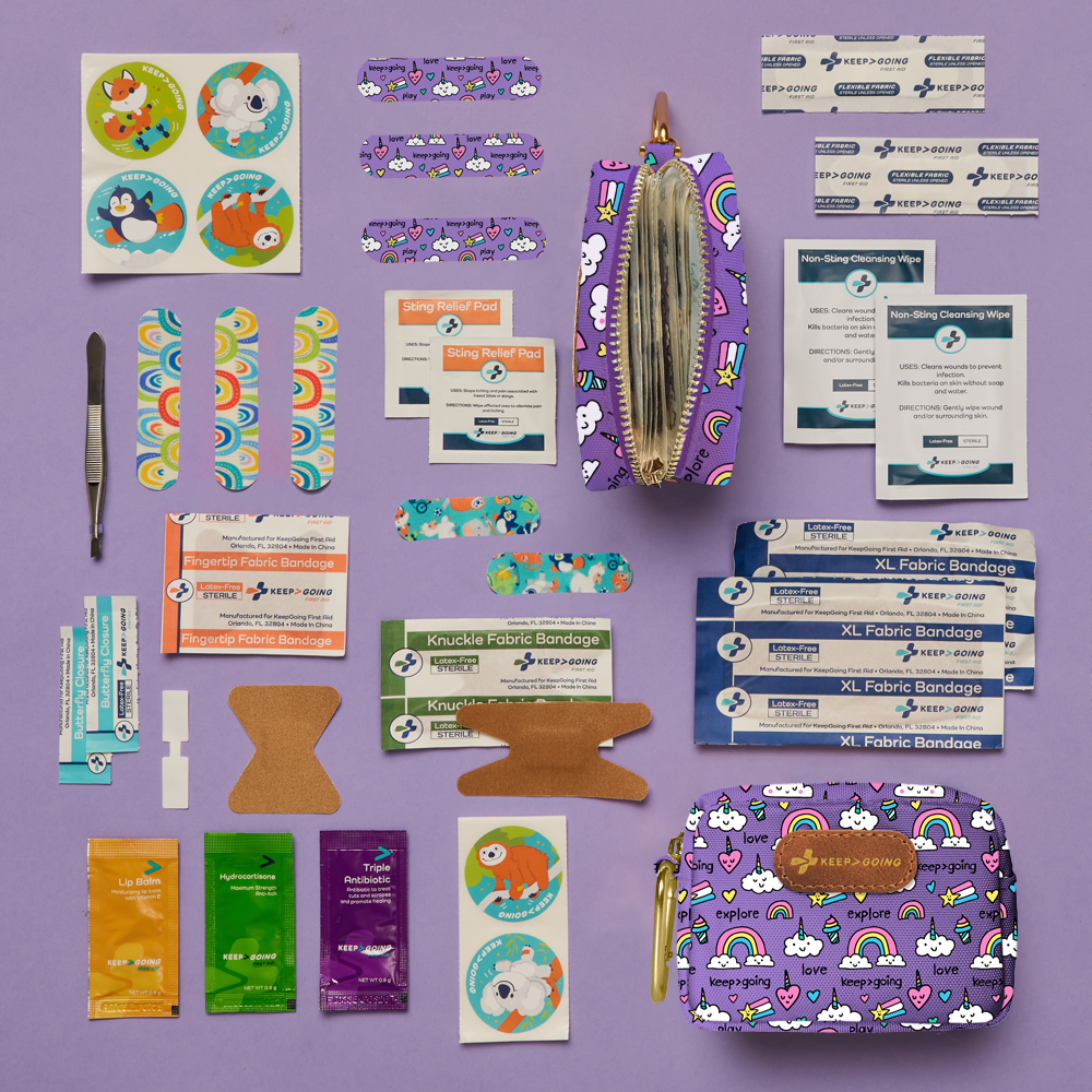 First aid kit with various supplies on a purple background