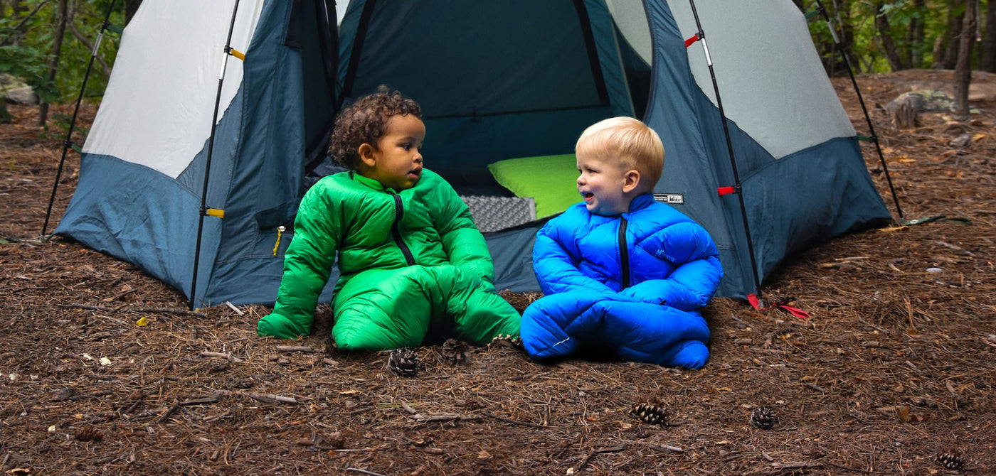 Two babies in Little Mo sleeping bags camping in tent happy outside and warm