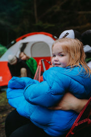 Toddler in Big Mo 40° Kids Sleeping Bag (Ages 2-4) Sitting in Chair Outside Camping Warm and Happy - Morrison Outdoors