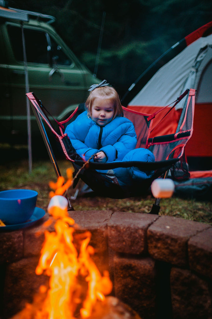 Toddler in Big Mo 40° Kids Sleeping Bag (Ages 2-4) Sitting around a Fire Camping Warm and Happy - Morrison Outdoors